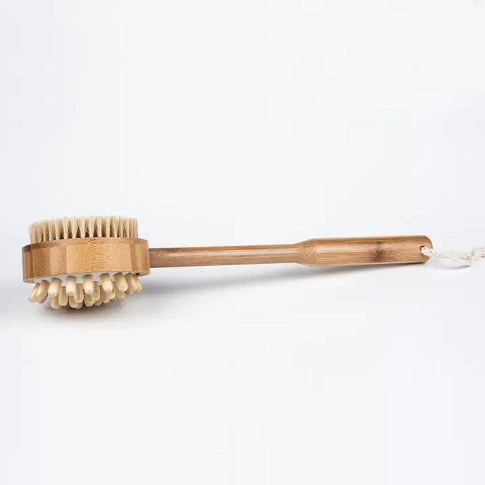 The BAUDELAIRE - BAMBOO 14" MASSAGE BRUSH by BAUDELAIRE has exfoliating boar’s hair bristles on one side and massage nubs on the other, displayed against a plain white background.