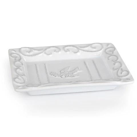 The CERAMIC SOAP DISH by EUROPEAN SOAPS, LLC features a white rectangular ceramic design with a raised border and embossed bird motif, inspired by Provence—an elegant touch for display or serving.
