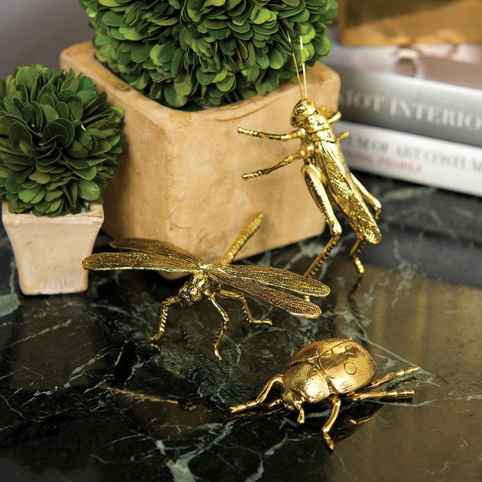 The ZODAX DECORATIVE GOLD LADYBUG is a small gold-colored figurine with detailed legs and body, measuring 2.75 x 2.5 x 1 inches, shown on a plain white background.