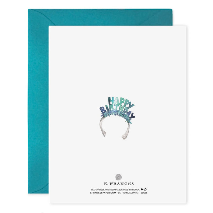 The E. FRANCES PAPER "Lucy Dog Birthday" card features a fluffy white dog in a blue birthday headband, paired with a teal envelope and printed on luxe heavyweight paper.