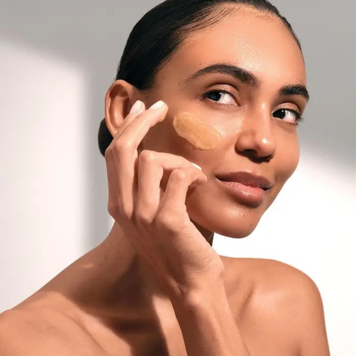 A blue tube of ELEMIS - PRO-COLLAGEN GLOW BOOST EXFOLIATOR by ELEMIS - STEINER stands upright with a silver cap against a white background, featuring the product name and details in silver and black on the front.