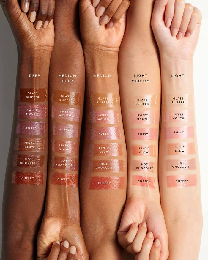 Side-by-side of five models' arms showing the six shades of Gloss Bomb Heat lip gloss on different skin tones.
