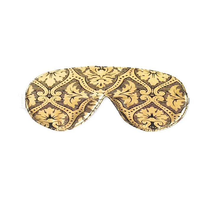 The GOLD DAMASK SLEEP MASK by E WIGHTMAN & CO features a curved design for comfort and showcases a vintage-inspired gold and black floral damask pattern.