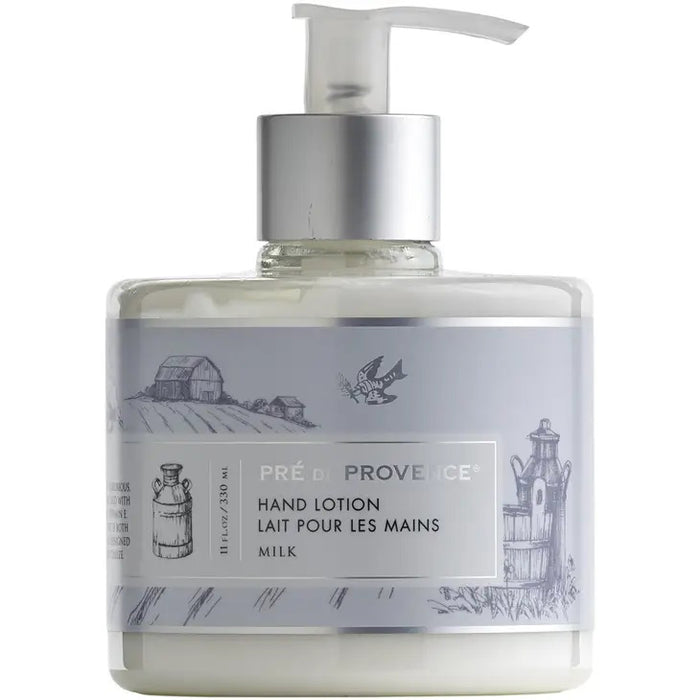 A clear pump bottle labeled "HERITAGE LOTION - MILK" by EUROPEAN SOAPS, LLC features gray and white rural barn, barrel, and bird artwork. This off-white moisturizing lotion contains shea butter and vitamin E.