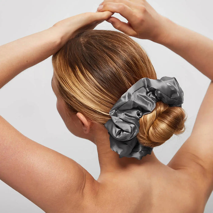 A KITSCH - SATIN SLEEP PILLOW SCRUNCHIES box includes two large satin scrunchies—one gold, one gray—shown outside the box to showcase their soft, frizz-reducing texture.
