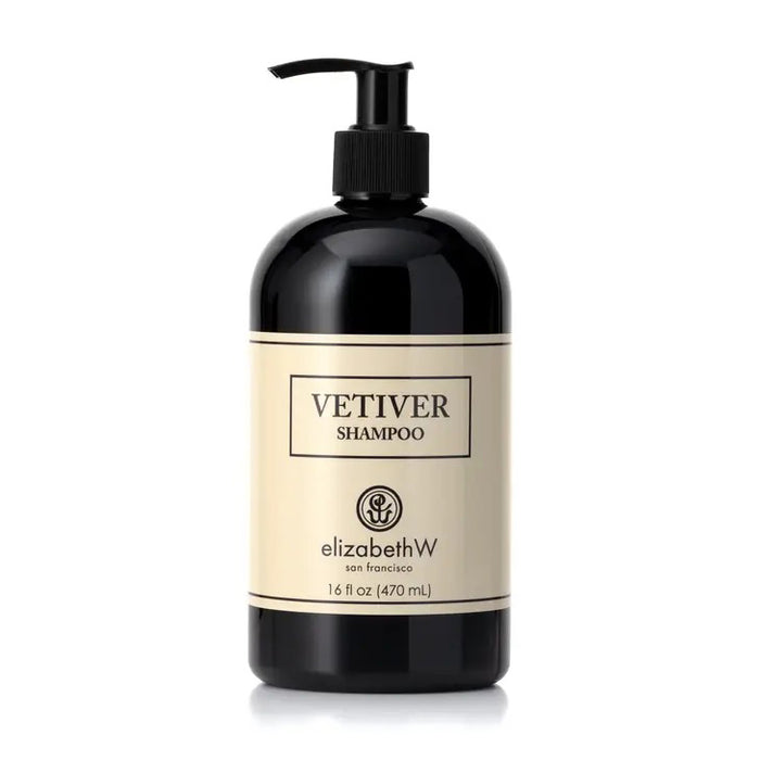 A sleek black bottle with a pump dispenser is labeled "VETIVER SHAMPOO" in bold letters on a beige background. The label also reads "E WIGHTMAN & CO" below the shampoo name, and the bottle size is indicated as 16 fl oz (470 ml). Perfect for all hair types, it features plant-based ingredients.