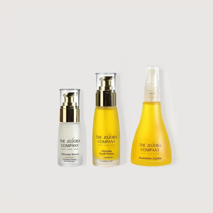 Three skincare products from The Jojoba Company on a light gray background