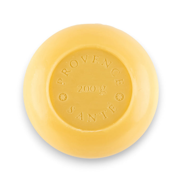 A green octagonal box labeled “BAUDELAIRE - BERGAMOT 7OZ BOXED BATH BAR,” featuring a yellow citrus slice design and containing a 200g French-milled soap enriched with shea butter, delivers a luxurious and refreshing bergamot fragrance. Made in France.
