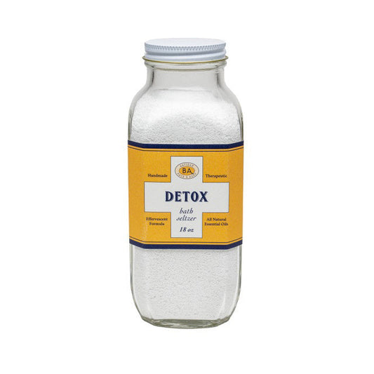 A clear glass jar of BAUDELAIRE DETOX BATH SELTZER 18oz features a yellow and blue label with "Handmade," "Therapeutic," and essential oils. Perfect for relaxing, effervescent soaks. Brand: BAUDELAIRE.