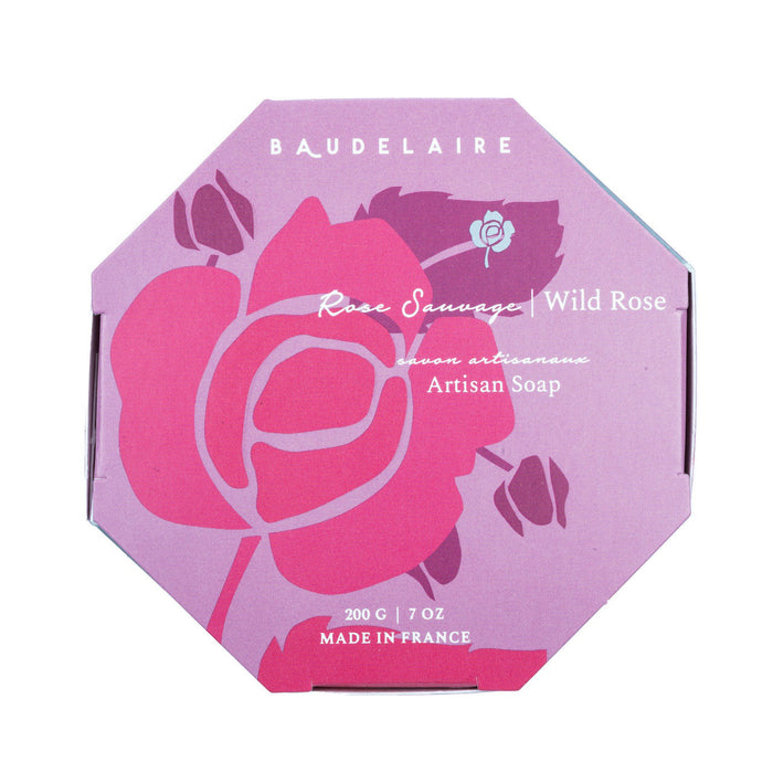 A hexagonal box of BAUDELAIRE Wild Rose 7oz Bath Bar, featuring a pink rose design and white text. This French-milled soap is enriched with shea butter, weighs 200g (7oz), and is marked “Made in France.”.