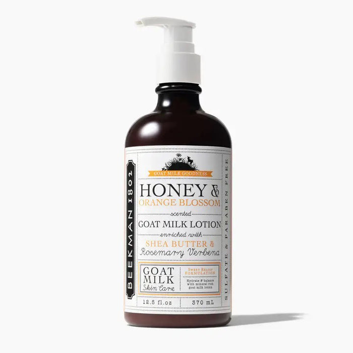 A brown bottle with a white pump labeled "BEEKMAN - HONEY AND ORANGE HAND LOTION 12.5OZ" from BEEKMAN - STA ELEMENTS, offering moisturizing hand care with a citrus scent in a 12.5 oz size.