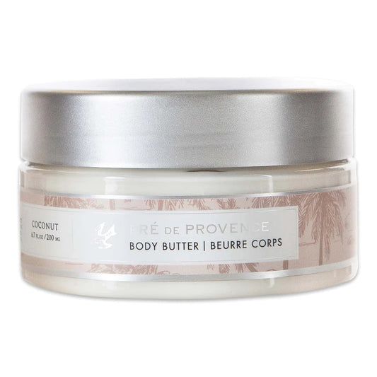 A clear plastic jar with a silver lid holds 200 ml (6.7 fl oz) of EUROPEAN SOAPS, LLC BODY BUTTER - COCONUT, enriched with Shea Butter to moisturize skin. The label indicates a coconut scent.