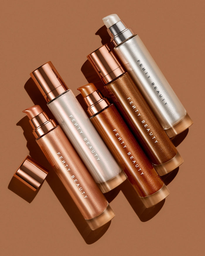 Fenty Beauty Body Lava bottles in various shades on a brown background