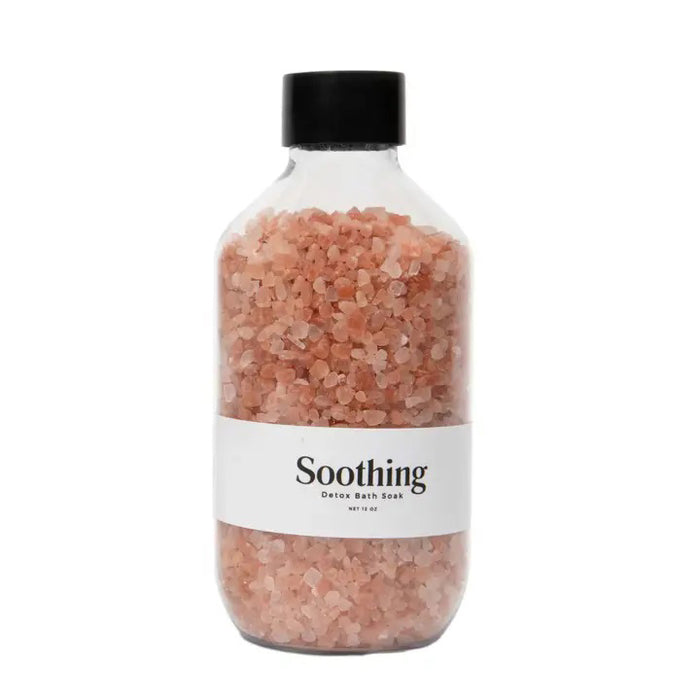 A clear plastic bottle with a black cap holds GIFTEN MARKET’s BOTANICAL BATH SOAK - SOOTHING DETOX, featuring pink Himalayan salt and a white label. Ideal for a relaxing lavender bath salts experience. Background is plain white.
