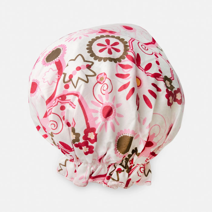A BATH ACCESSORIES COMPANY BOUFFANT SHOWER CAP - BELLEZA, featuring a pink and brown floral pattern with an elastic band, is displayed against a plain white background.