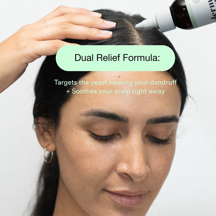 Woman applying Dermazen Calming Seborrheic Serum to her scalp, text: “Dual Relief Formula: Targets the yeast causing your dandruff + Soothes your scalp right away.”