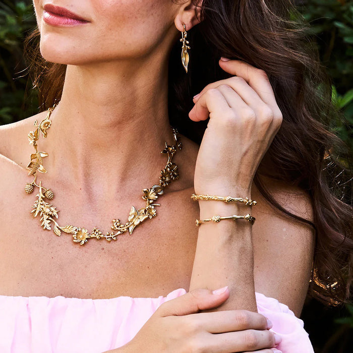 The CAPUCINE DE WULF Meadow Ladybug Petite Bangle is a handmade gold bangle bracelet with an open design and textured elements resembling ladybugs, featuring a polished finish for elegance.