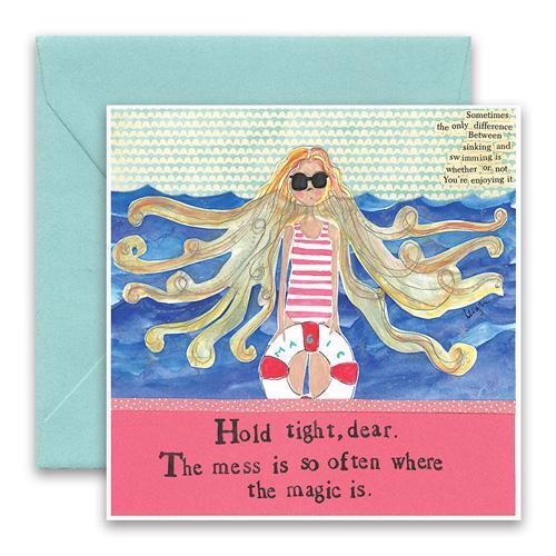 The CURLY GIRL DESIGNS - MESS GREETING CARD by CURLY GIRL DESIGN, INC features a whimsical illustration of a blonde girl in sunglasses by the sea. Text: “Hold tight, dear. The mess is so often where the magic is.” Includes blue envelope.