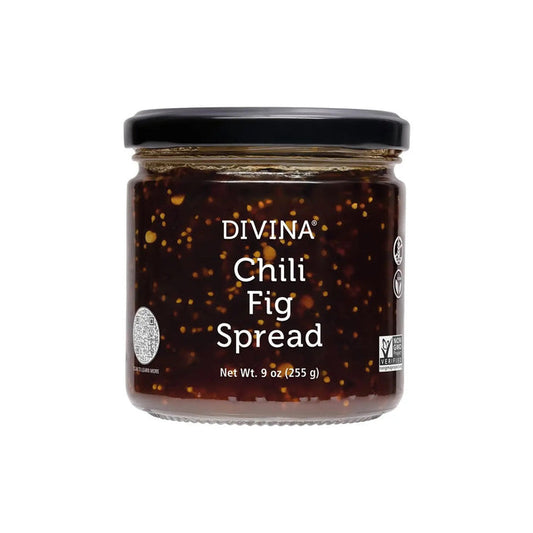 A jar of DIVINA - CHILI FIG SPREAD with a black lid features a label displaying its name and weight, 9 oz (255 g). This dark, sweet, spicy spread with visible seeds is non-GMO and vegan certified—ideal for cheese pairing.