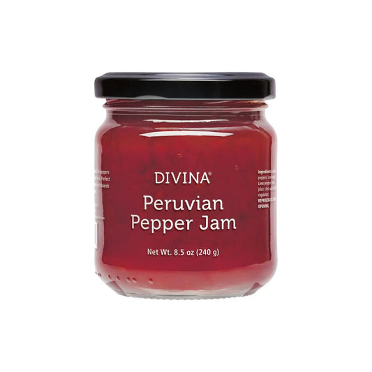 A glass jar of DIVINA - PERUVIAN PEPPER JAM features a black lid and a label displaying "Peruvian Pepper Jam" and "Net Wt. 8.5 oz (240 g)" in white, highlighting the rich red jam infused with exotic Limo peppers.