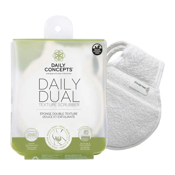 The DAILY CONCEPTS DUAL TEXTURE SCRUBBER, shown next to a white mitt, features gentle exfoliation for daily use, organic cotton material, smart technology icons, and comes in reusable packaging.