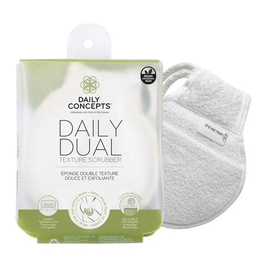 The DAILY CONCEPTS DUAL TEXTURE SCRUBBER, shown next to a white mitt, features gentle exfoliation for daily use, organic cotton material, smart technology icons, and comes in reusable packaging.