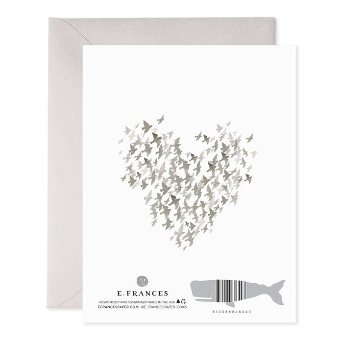 The E. FRANCES PAPER - STARLINGS CONDOLENCE GREETING CARD features a heart made of small gray birds on luxurious paper. Below, "SO SORRY" is printed in muted pink. An elegant envelope is partially visible behind the card.