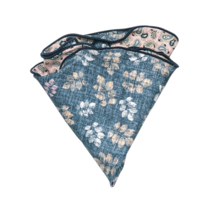The EDWARD ARMAH Reversible Silk Pocket Circle in Pink Denim Leaf features blue and beige floral patterns on one side and a contrasting pink and green paisley print on the reverse.