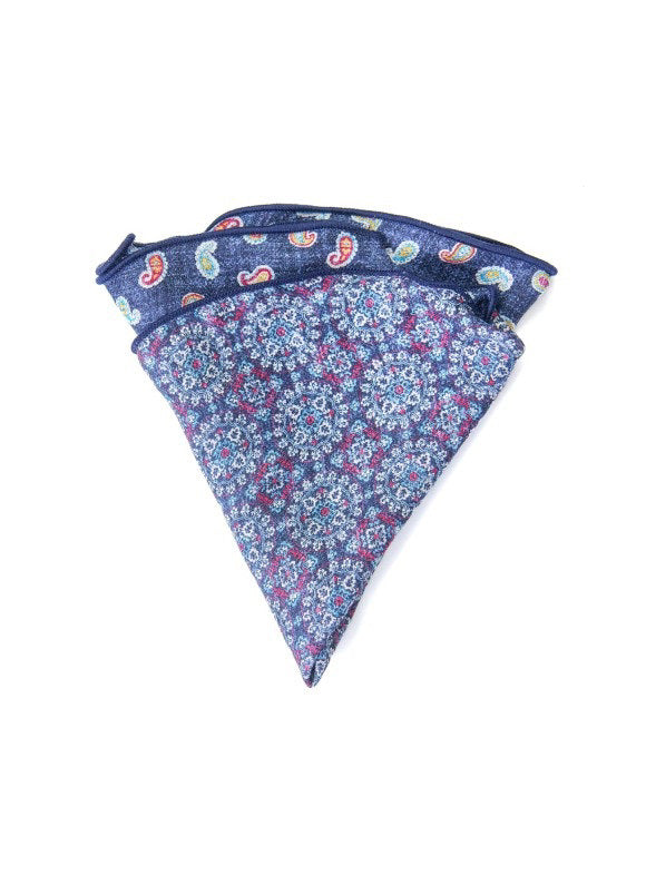 The EDWARD ARMAH Silk Reversible Pocket Circle Denim Paisley features a blue silk design with a purple and white floral pattern and a paisley print on the reverse side.