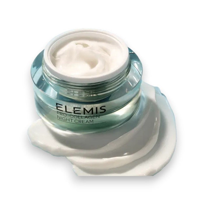 An open jar of ELEMIS - STEINER ELEMIS - PRO COLLAGEN NIGHT CREAM 50ML rests on a white surface, with some of the anti-aging moisturizer artistically spread around its base.