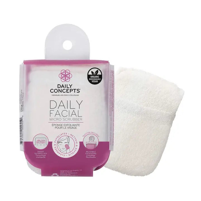 A white DAILY CONCEPTS FACIAL MICRO SCRUBBER, a gentle exfoliator and make-up remover for sensitive skin, comes in pink and white packaging that highlights its organic cotton content.