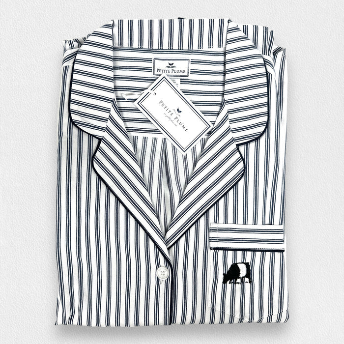A folded PETITE PLUME Women's Twill Pajama Top from the FEARRINGTON LIFESTYLE COLLECTION, featuring navy French ticking stripes, long sleeves, a front pocket with small animal embroidery, and a tag by the collar.