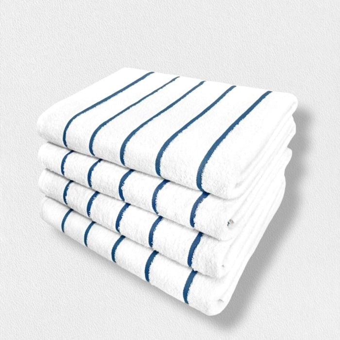 Four white cotton FEARRINGTON LIFESTYLE POOL TOWELS by Frette North America, featuring blue stripes and fade-resistant quality, are neatly stacked against a light textured background for a timeless look.