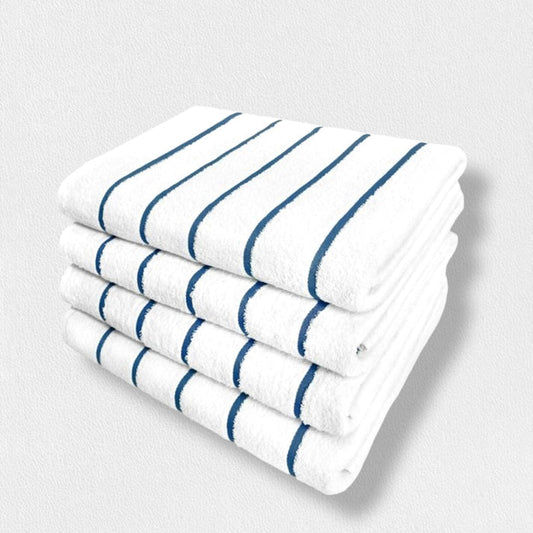 Four white cotton FEARRINGTON LIFESTYLE POOL TOWELS by Frette North America, featuring blue stripes and fade-resistant quality, are neatly stacked against a light textured background for a timeless look.