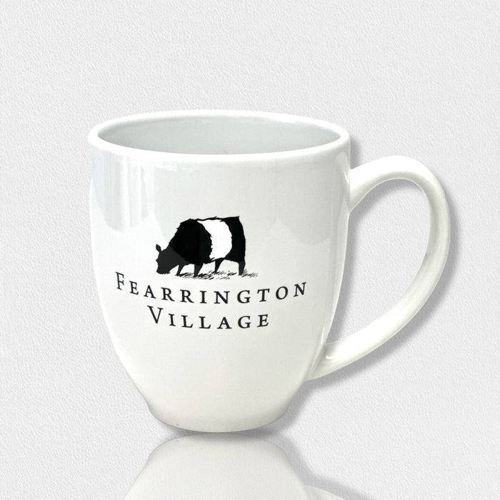 The FEARRINGTON SIGNATURE COLLECTION - FEARRINGTON COFFEE MUG 1 COW 3RD EDITION by STRAN PROMOTIONAL SOLUTIONS is a 16 oz white ceramic mug with a black and white cow illustration and "Fearrington Village" text, handle shown on the right side.