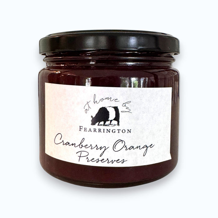 The Fearrington Housemade Cranberry Orange Preserves from the Fearrington Signature Collection, featuring a white label, are perfect breakfast jams. Made with cranberries, orange zest, cinnamon, sugar, port, and pectin by Fearrington chefs, they make an ideal handmade hostess gift. Allergen info is on the label.