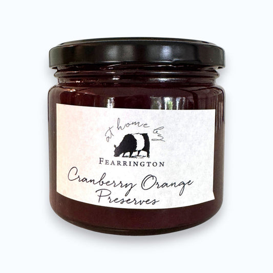 The Fearrington Housemade Cranberry Orange Preserves from the Fearrington Signature Collection, featuring a white label, are perfect breakfast jams. Made with cranberries, orange zest, cinnamon, sugar, port, and pectin by Fearrington chefs, they make an ideal handmade hostess gift. Allergen info is on the label.