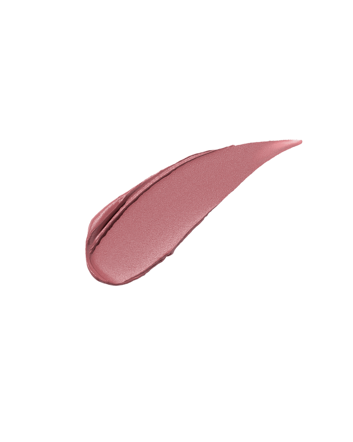 A smear of Fenty Icon Velvet lipstick in light pink color on a light background.