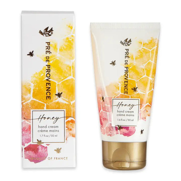 EUROPEAN SOAPS, LLC HONEY HAND CREAM (1.7 fl oz/50 ml) comes in a tube and box decorated with honeycomb, bees, and yellow-pink watercolor accents. Enriched with organic honey for deep moisture. Gold-colored text adds an elegant touch.