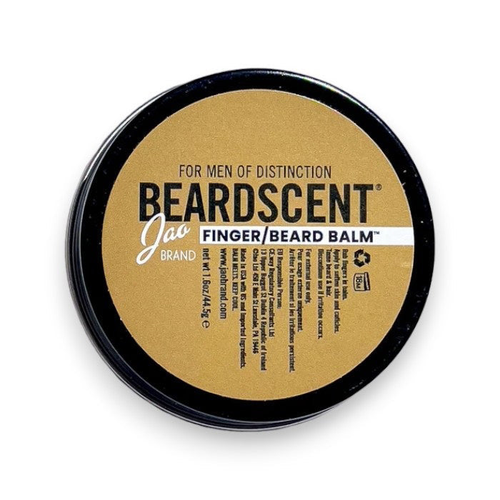 A round tin with a gold lid labeled "JAO BRAND - BEARDSCENT" by JAO LIMITED. This essential oil beard balm has a detailed label and a barcode on the right side.