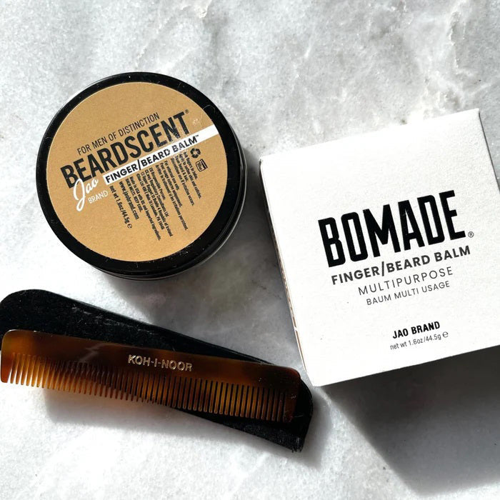 A round tin with a gold lid labeled "JAO BRAND - BEARDSCENT" by JAO LIMITED. This essential oil beard balm has a detailed label and a barcode on the right side.
