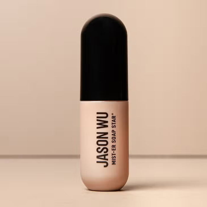 A bottle of JASON WU BEAUTY JASON WU - MIST-ER SOAP STAR BROW SOAP, ideal for brow styling routines, stands upright with a beige base and black cap against a neutral background. The product name appears vertically on the bottle.