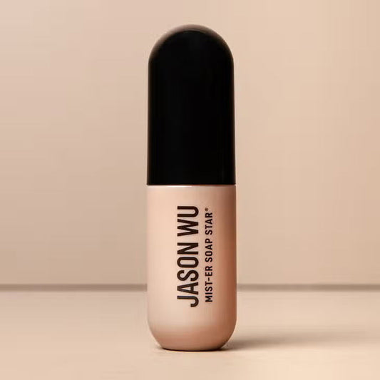 A bottle of JASON WU BEAUTY JASON WU - MIST-ER SOAP STAR BROW SOAP, ideal for brow styling routines, stands upright with a beige base and black cap against a neutral background. The product name appears vertically on the bottle.