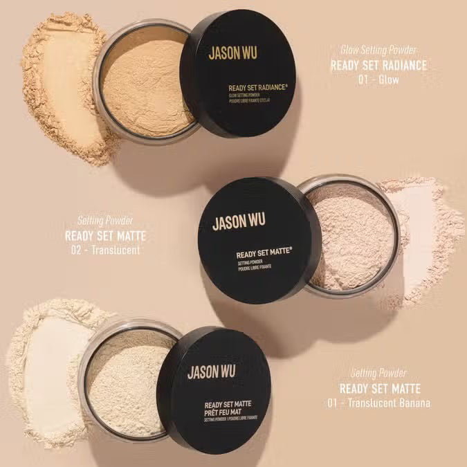 A black, round JASON WU BEAUTY container labeled "READY SET MATTE 2" rests on a beige geometric background. The clear base displays translucent setting powder inside, ideal for a flawless matte finish.