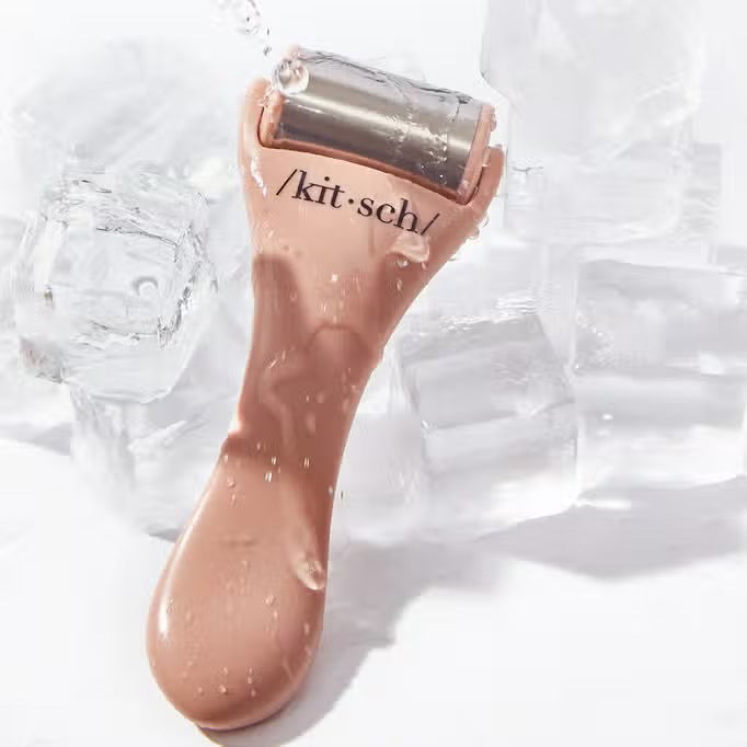 The beige packaging of the "KITSCH - ICE FACE ROLLER," featuring surgical stainless steel, suits sensitive skin. Made from recycled plastic, circular icons on it emphasize benefits like enhanced blood circulation.