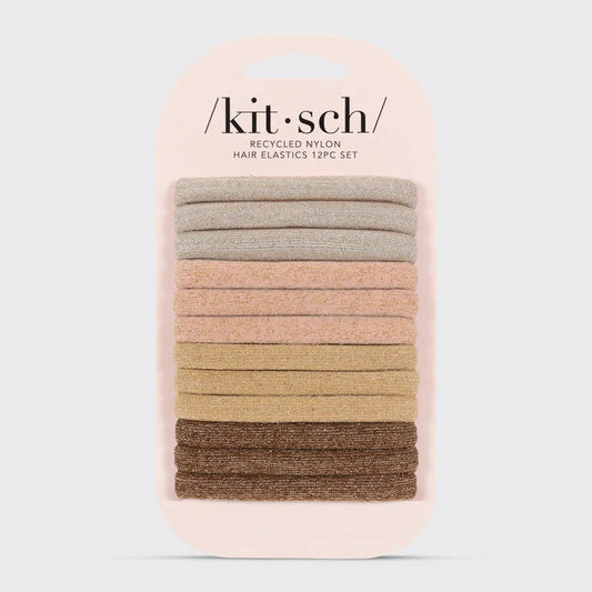 A 12-pack of KITSCH Recycled Glitter Nylon Hair Elastics features eco-friendly glittery ties in neutral shades, arranged light to dark, displayed on a branded light pink card.