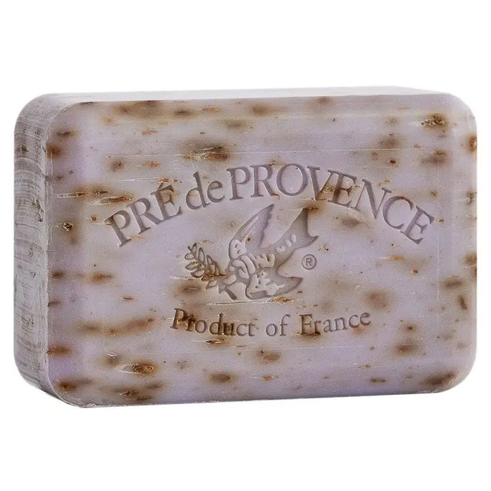 EUROPEAN SOAPS, LLC LAVENDER BAR SOAP 250G is a rectangular French soap bar with brown speckles, embossed with "PRE de PROVENCE," a bird with an olive branch, and "Product of France"; shea enriched for a luxurious touch.