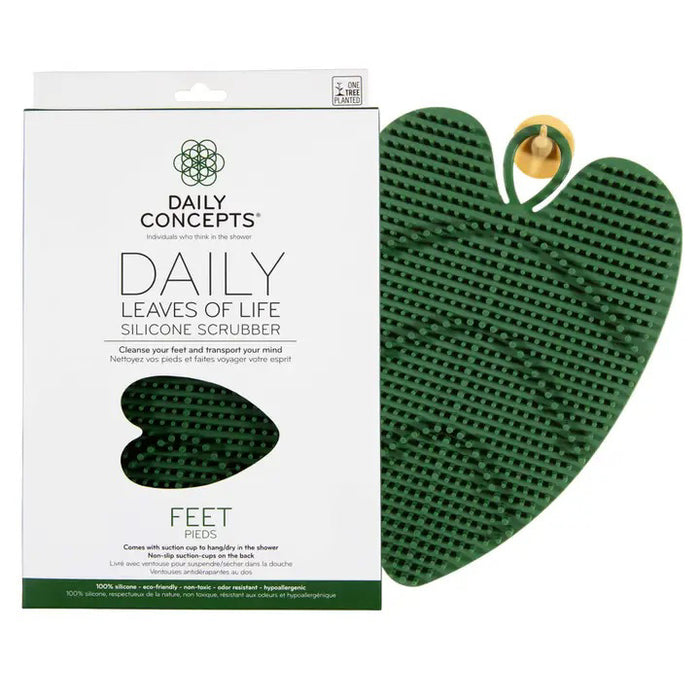 The DAILY CONCEPTS LEAVES OF LIVE FOOT SCRUBBER is a green, heart-shaped silicone tool with textured ridges, ideal for exfoliating and cleaning feet in the shower. Hypoallergenic and comes in branded packaging.