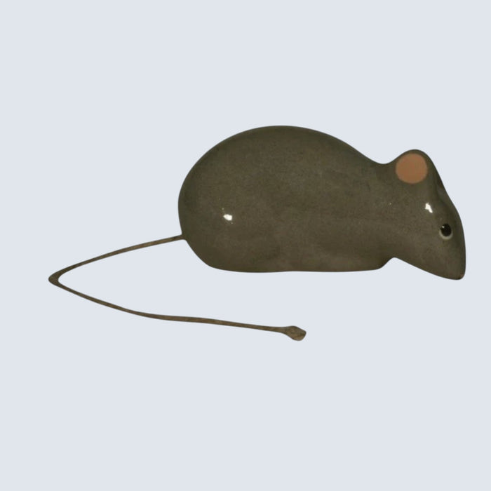 The LES CERAMIQUES DE LUSSAN - GREY LYING DOWN MOUSE by LES CERAMIQUES DE LUSSAN is a handmade ceramic figurine featuring a glossy gray body, a pink ear, a black eye, and a thin, straight tail, displayed on a white background.