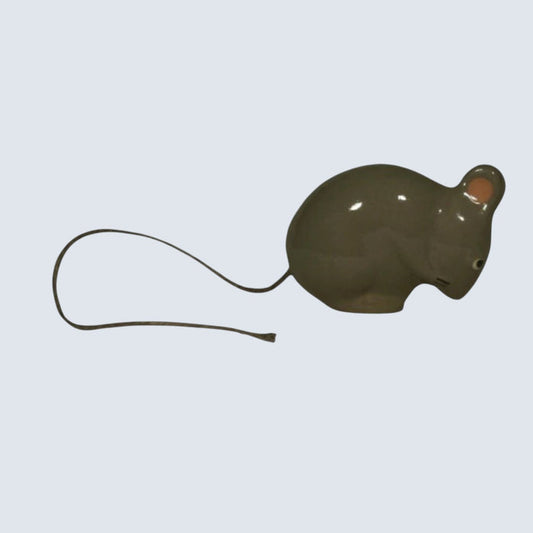 The LES CERAMIQUES DE LUSSAN - GREY SITTING MOUSE features a delicate gray ceramic body, long slender tail, and charming pink details inside its ears, all set against a white background. Handmade by LES CERAMIQUES DE LUSSAN, this delightful figurine pairs perfectly with any of the brand's ceramic cats and showcases the exquisite artistry of handcrafted ceramics.